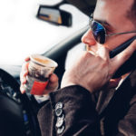 Man talking on phone while driving.jpg.crdownload